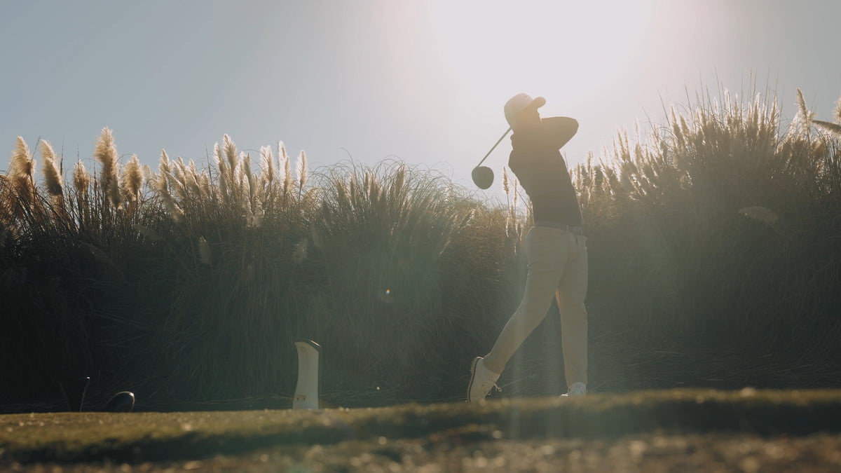 Golfer using a portable launch monitor at a driving range 